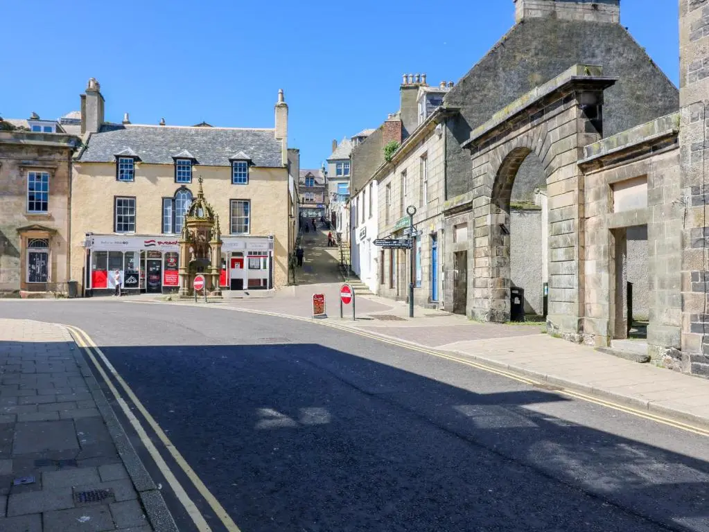 an empty street in a town with stone buildings at 1A Carmelite Street in Banff
