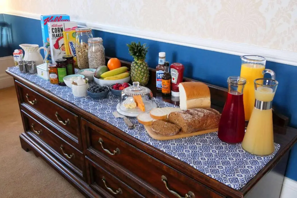 a table with breakfast foods and drinks on it at The Gordon Guest House in Ballater