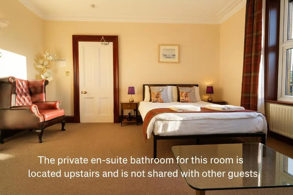 a hotel room with a bed and a chair at Tanera in Inverness