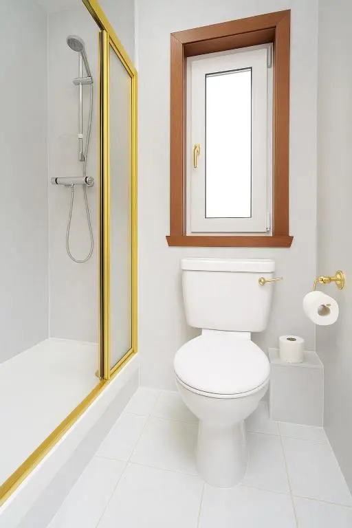 a bathroom with a toilet and a window and a shower at Tanera in Inverness