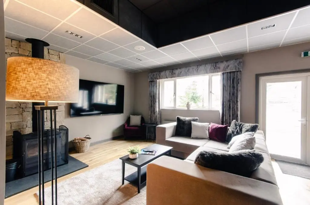 a living room with a couch and a fireplace at Sweeney Aviemore Two in Aviemore