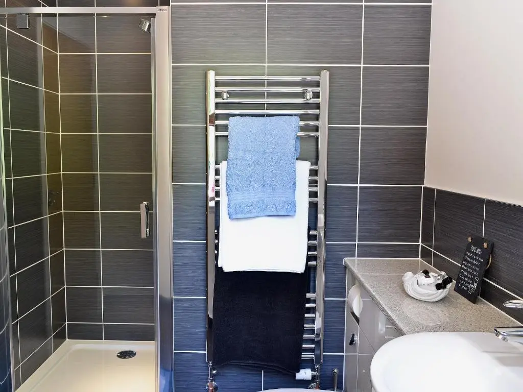 a bathroom with a towel rack and a shower at Cairn View in Strachan