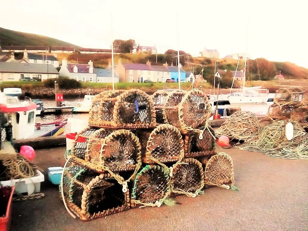 a pile of nets sitting on top of a marina at Selkie House Sea Song in Helmsdale