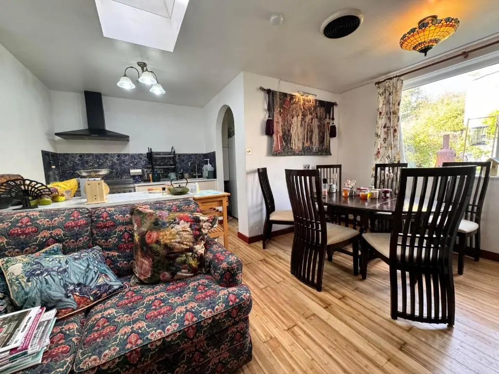 a living room with a couch and a table at Selkie House Sea Song in Helmsdale