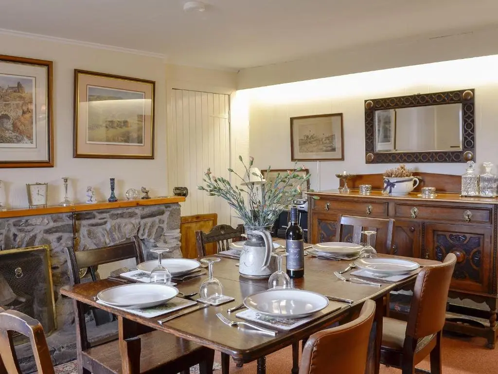a dining room with a table and chairs and a counter at Dalvanie Mill - S4241 in Tulchan