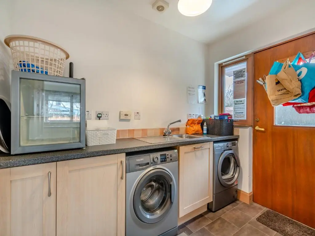 a kitchen with a washing machine and a sink at Cairn View - S4402 in Inverdruie