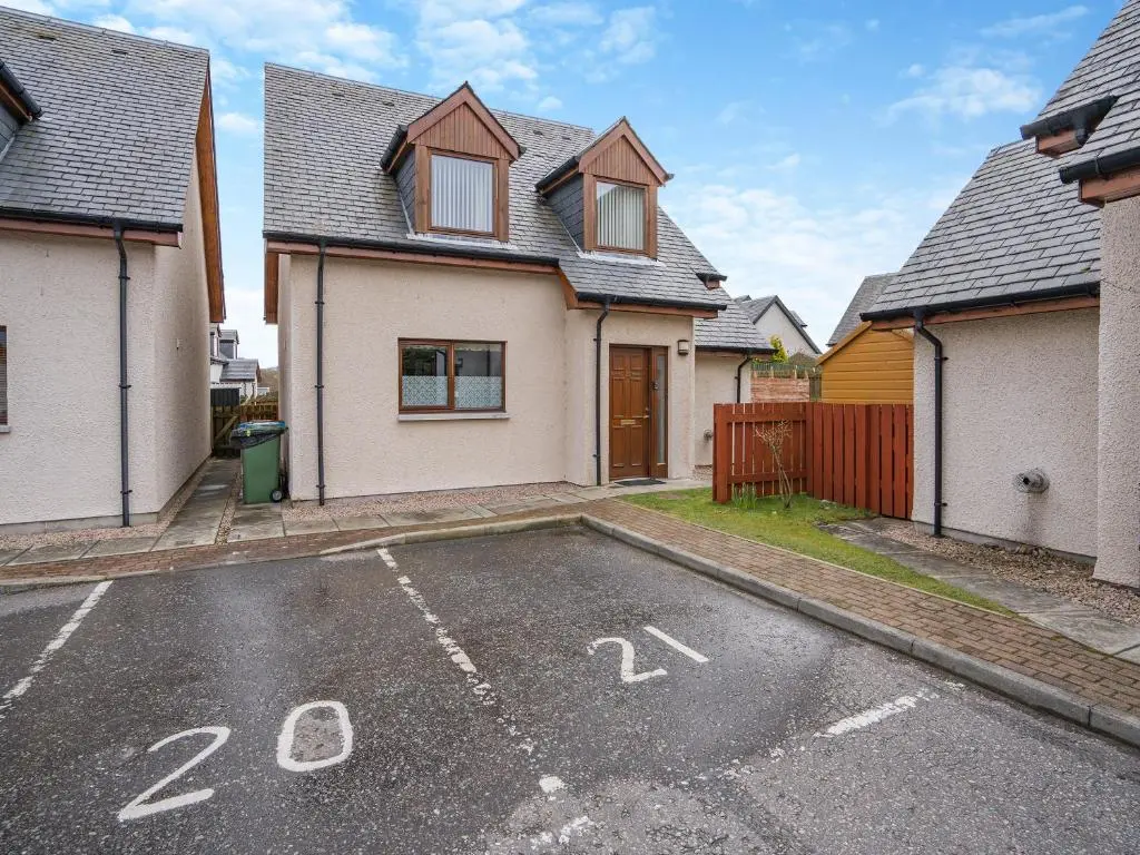 an empty parking lot in front of a house at Clunnie Mor - S4615 in Aviemore