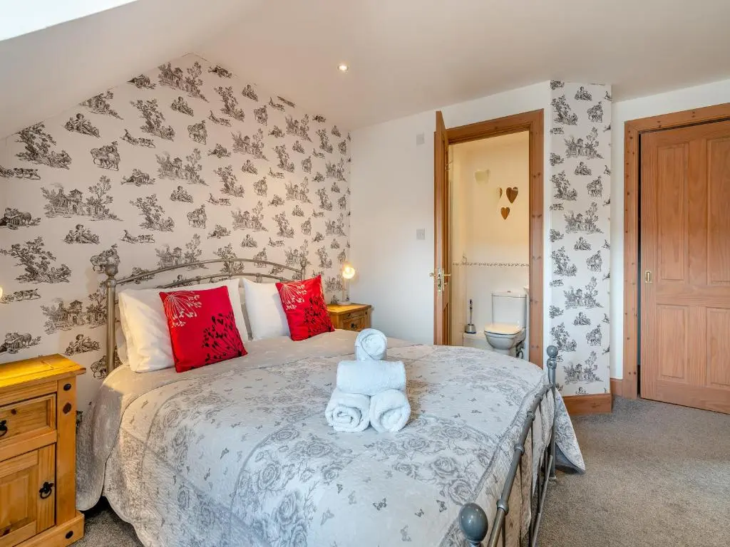 a bedroom with a bed with a teddy bear on it at Clunnie Mor - S4615 in Aviemore