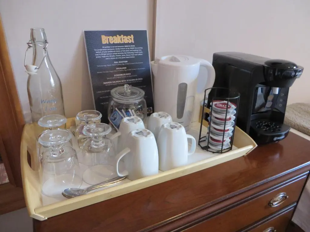 a tray with cups and other items on a dresser at Eriskay Guest House and Aviemore Glamping in Aviemore