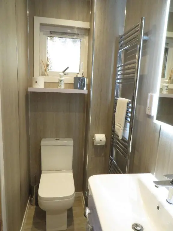 a small bathroom with a toilet and a sink at Eriskay Guest House and Aviemore Glamping in Aviemore