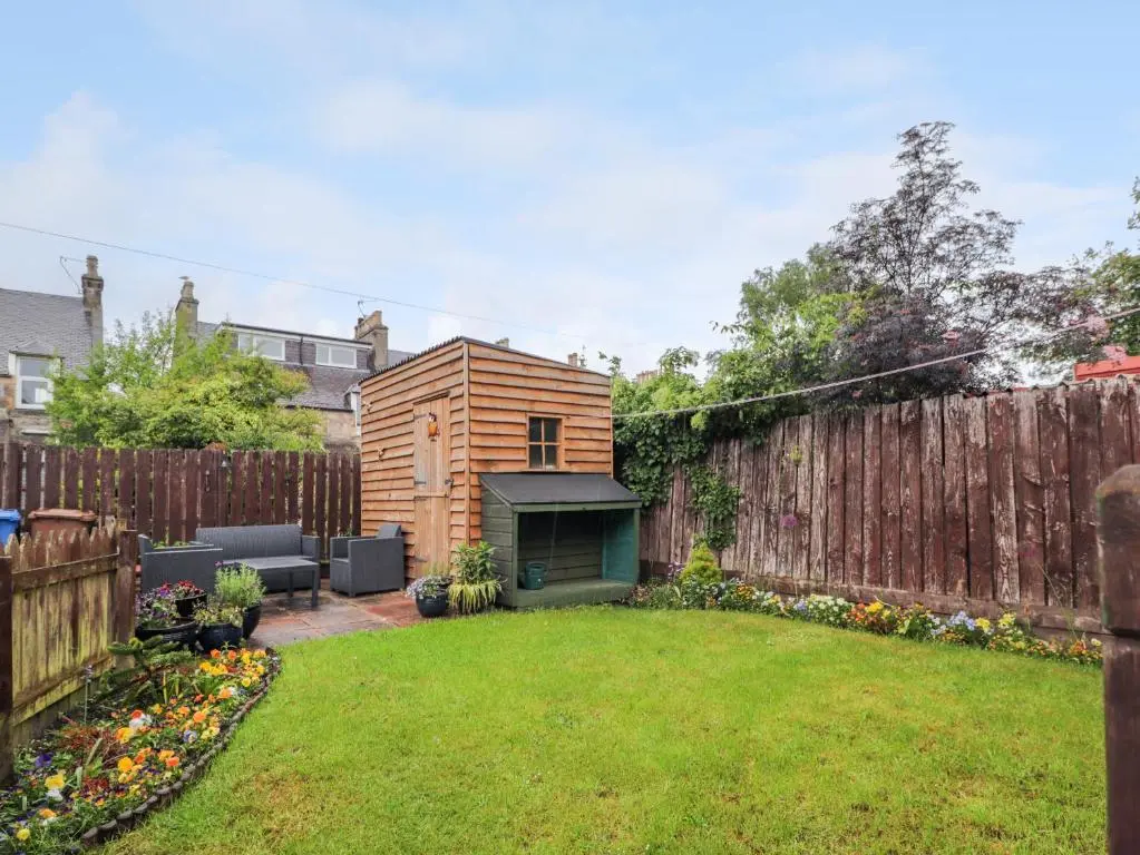 a small backyard with a wooden fence at Garry Isle in Inverness