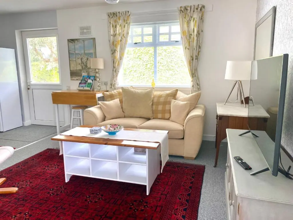 a living room with a couch and a table at Glenburn, Peaceful Accommodation Fochabers in Fochabers
