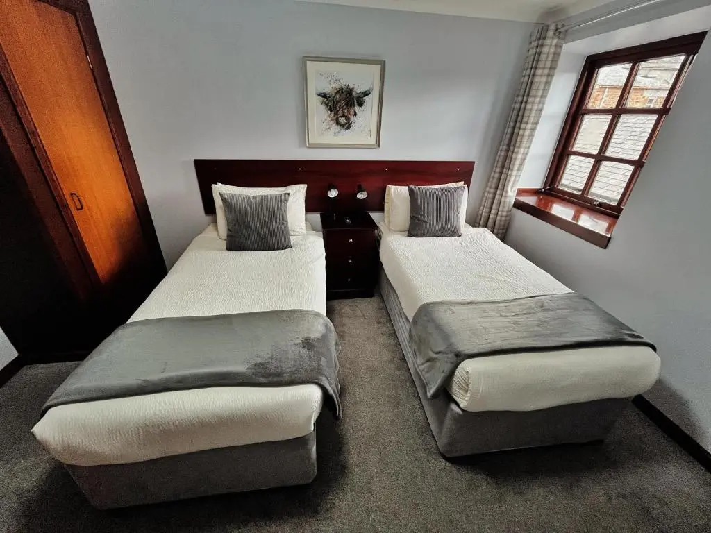 a bedroom with two beds in a room at The Stag Hotel in Banchory