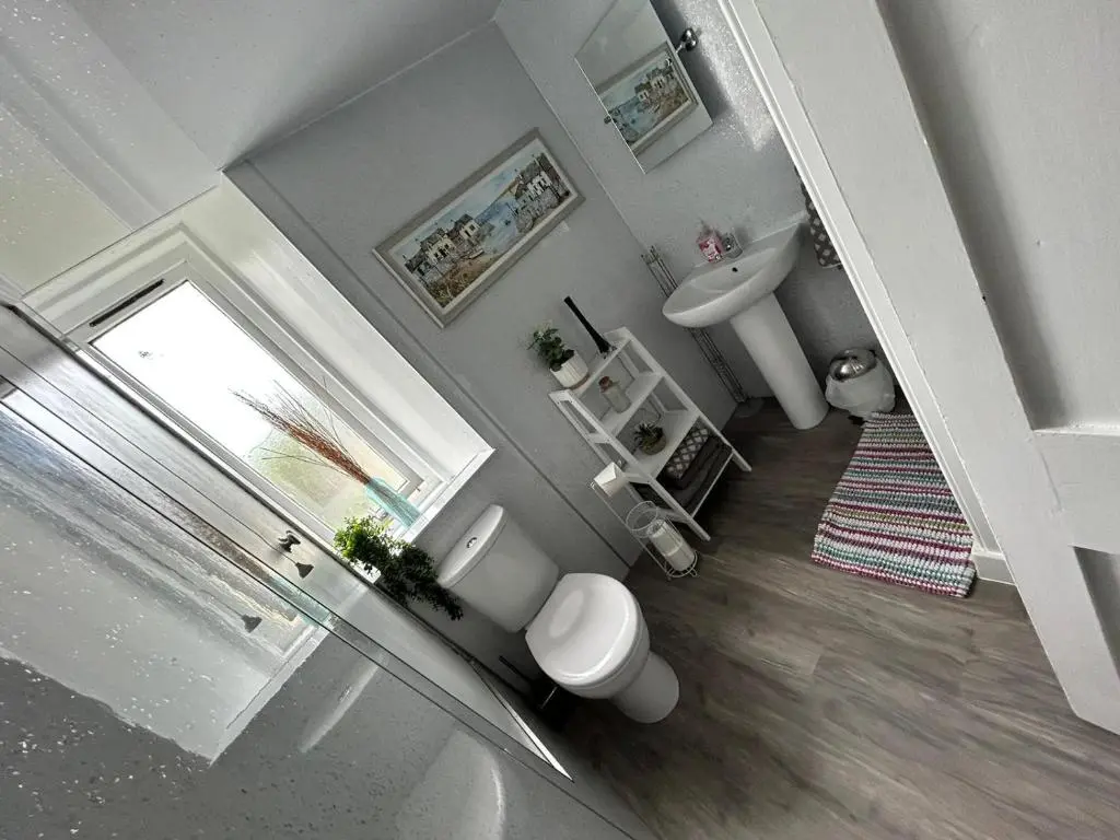 a bathroom with a toilet and a sink at St Duthus Hotel in Tain