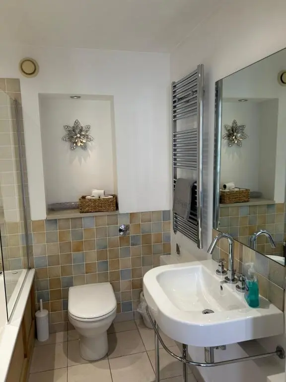 a bathroom with a toilet and a sink at 1 Bedroom Castleview Apartment 404-Free Parking in Inverness