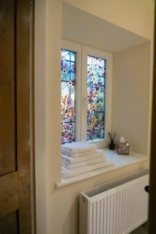 a room with a window with towels and a radiator at The Potted Pineapple in Oyne