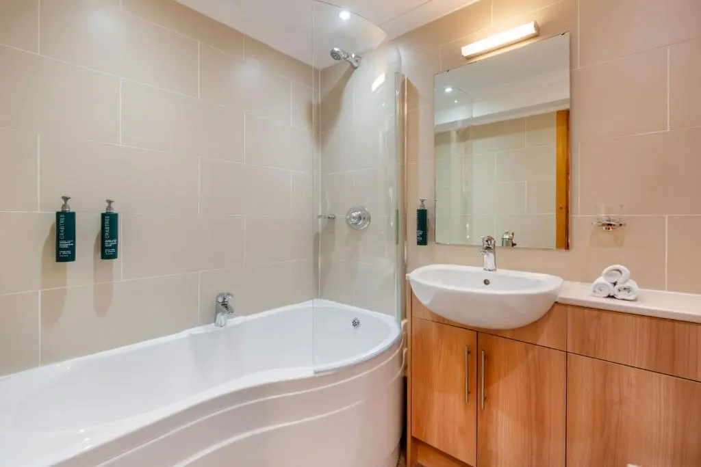 a bathroom with a white tub and a sink at The Lodges at Craigendarroch Country Club in Ballater