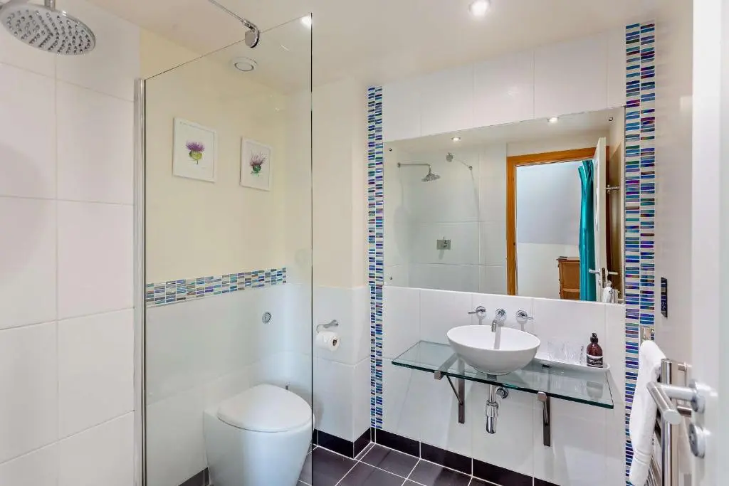 a white bathroom with a sink and a toilet at Sealladh an Loch in Foyers