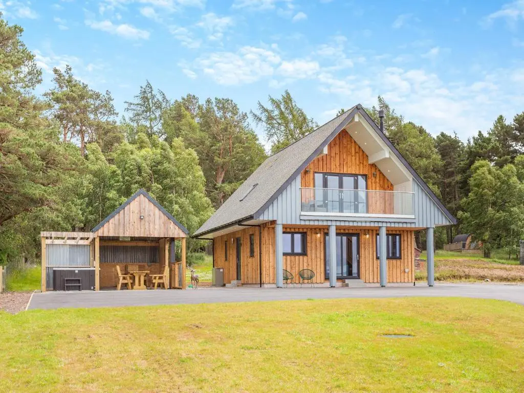 a barn style house with a patio and aestead at The Larches - Uk46804 in Culbokie
