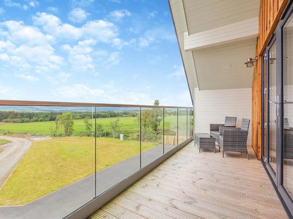 a balcony with a view of a field at The Larches - Uk46804 in Culbokie