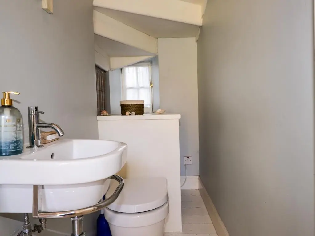 a bathroom with a sink and a toilet at Seashell Cottage in Cromarty