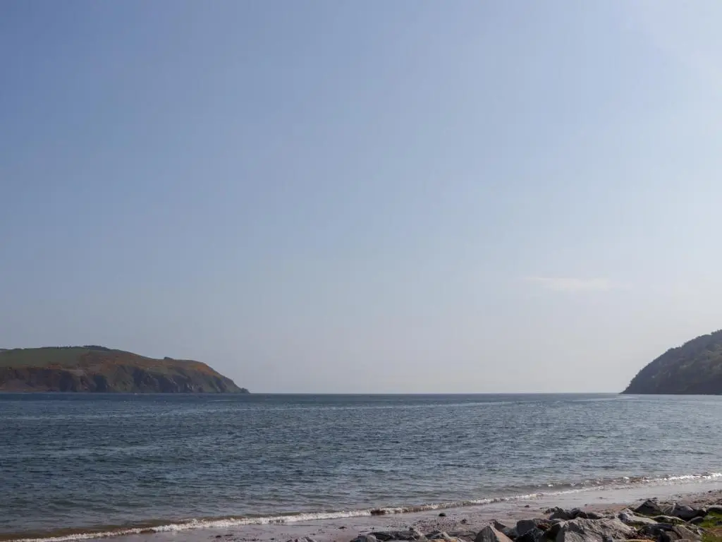 a body of water with a beach in the foreground at Seashell Cottage in Cromarty
