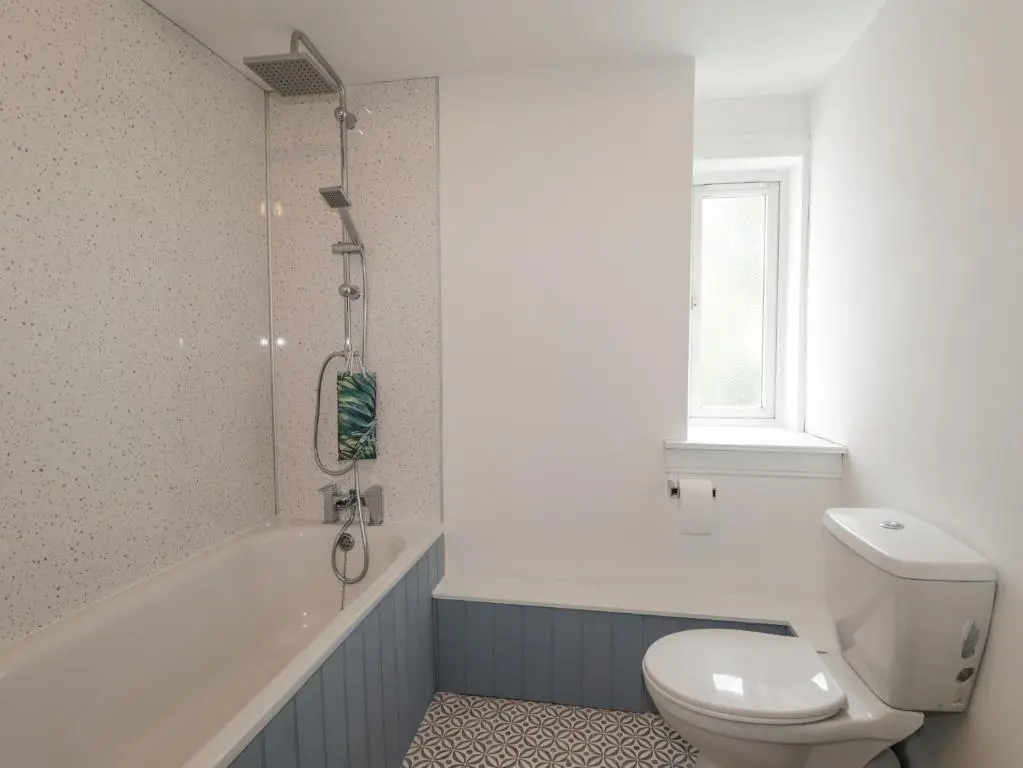 a bathroom with a toilet and a bath tub at Apartment in Foyers in Inverness