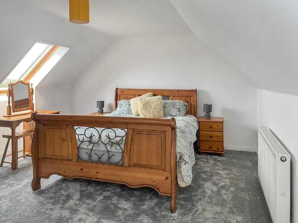 a bedroom with a bed with a dresser and a window at Guise Cottage Uk46303 in Tough