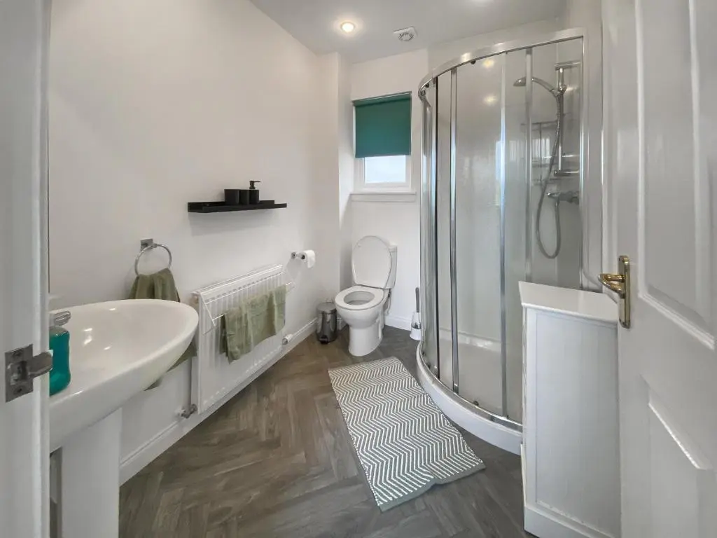 a bathroom with a shower and a sink and a toilet at Guise Cottage Uk46303 in Tough