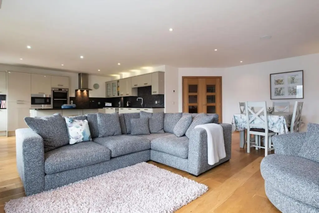 a living room with a couch and two chairs at The Steadings in Aviemore