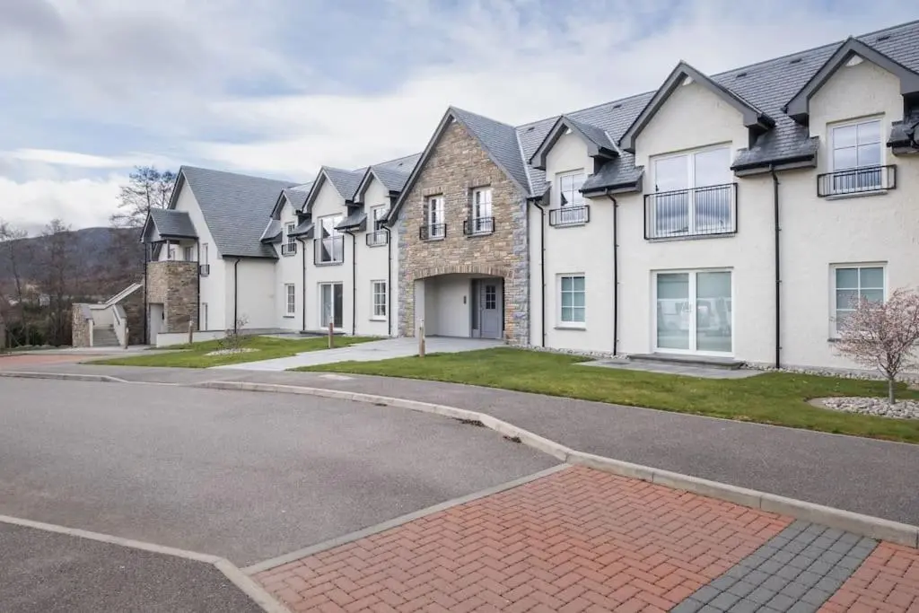 a large house with a driveway in front of it at The Steadings in Aviemore
