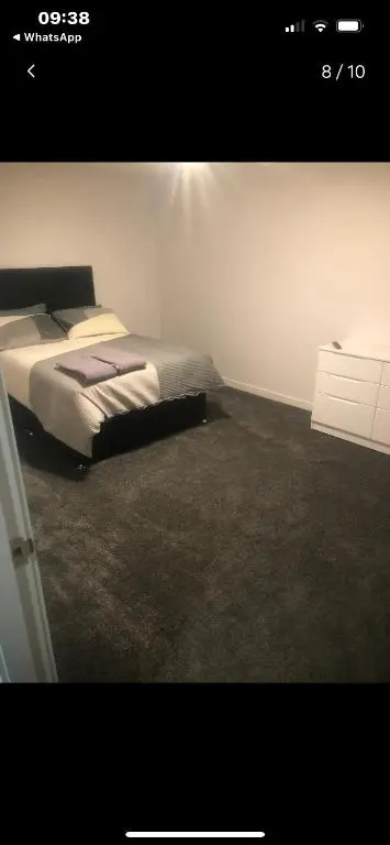 a bedroom with a bed and a white wall at Lisbon 67 in Wick