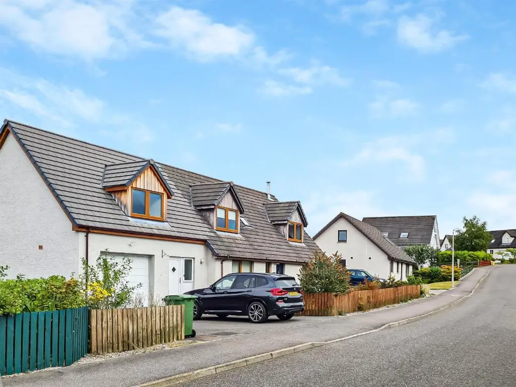 a black car parked in front of a house at Beinn View House in Cononbridge