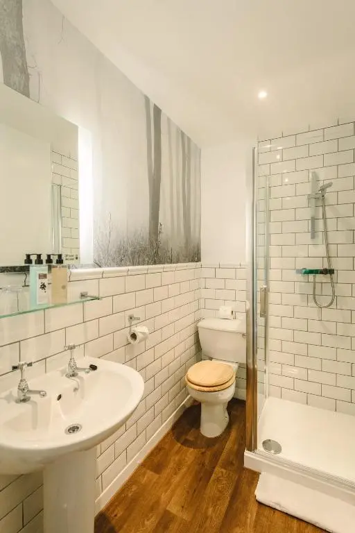 a bathroom with a sink and a toilet and a shower at Boat Country Inn and Restaurant in Boat of Garten