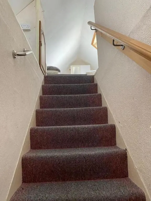 a staircase in a house with brown carpet at 2 Bed Cottage Sleeps 4-Pets Welcome-Private Garden in Buckie