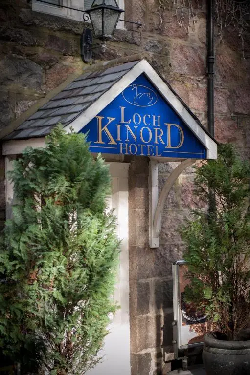 a sign for a hotel on the side of a building at Loch Kinord Hotel in Dinnet