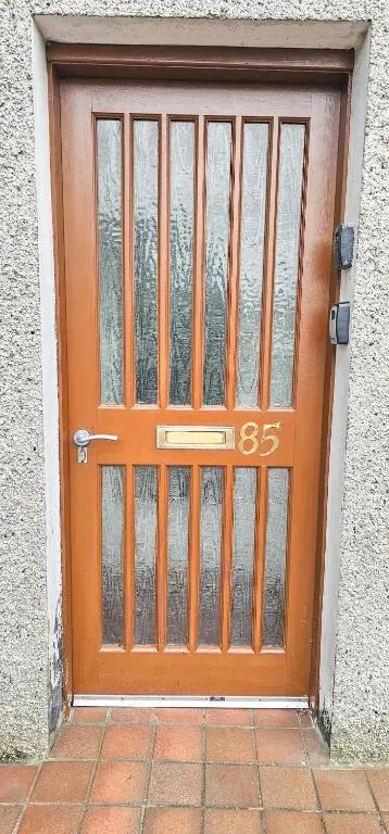 an orange door with a number on it at 1 Bedroom House - Inverness - River Canal in Inverness