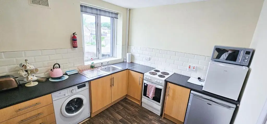 a kitchen with a sink and a stove top oven at 1 Bedroom House - Inverness - River Canal in Inverness