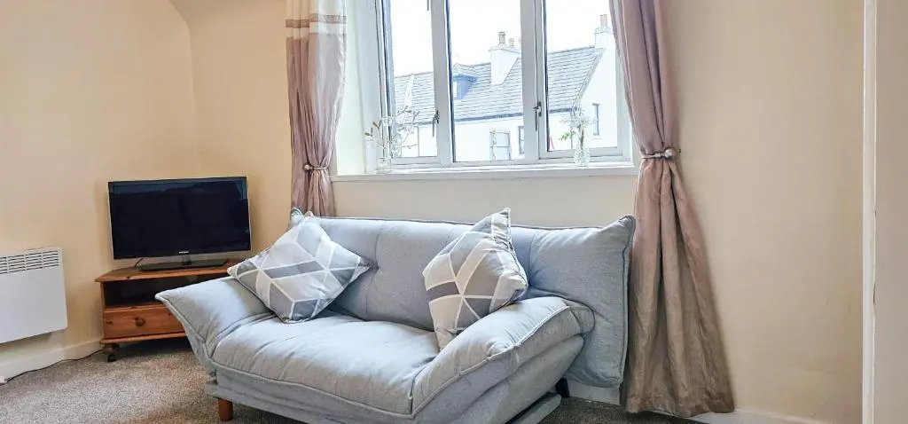 a living room with a couch and a window at 1 Bedroom House - Inverness - River Canal in Inverness