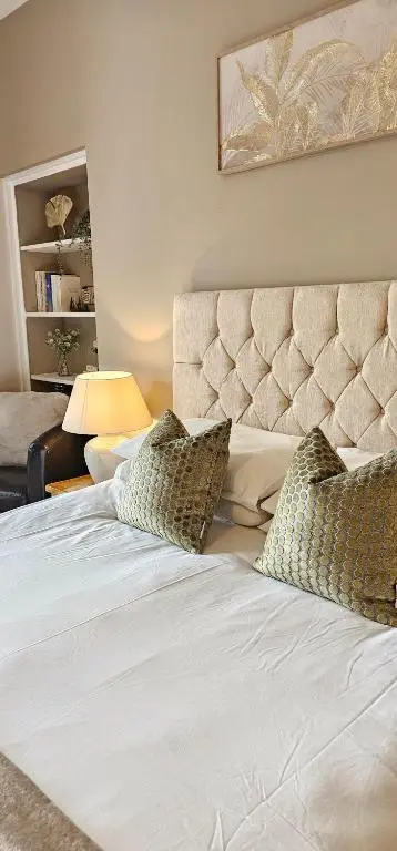 a bed with two pillows on it in a bedroom at Balmore Farmhouse near Lochness in Inverness
