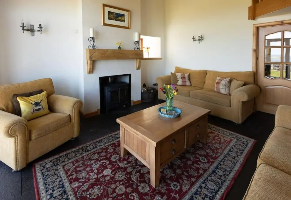a living room with two couches and a coffee table at Balvraid Steading - Awesome views, near Dornoch in Dornoch
