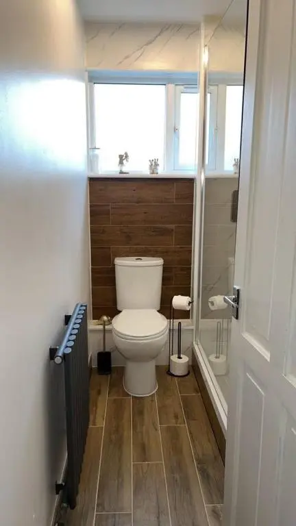 a small bathroom with a toilet and a window at Two Bedroom Hilton Apartment 1st floor in Inverness