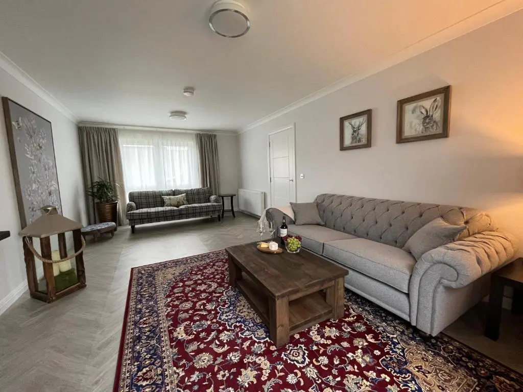 a living room with a couch and a coffee table at The Beech House in Aviemore