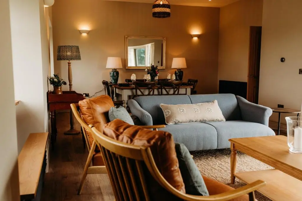 a living room with a couch and a table at No1 Burgie Mains Cottage in Forres