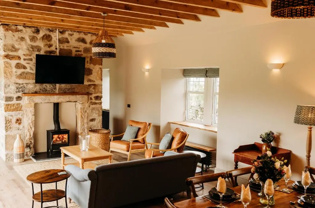a living room with a couch and a fireplace at No1 Burgie Mains Cottage in Forres