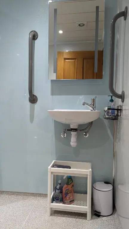 a bathroom with a sink and a mirror at The Wee Heilan' Coo in Nairn