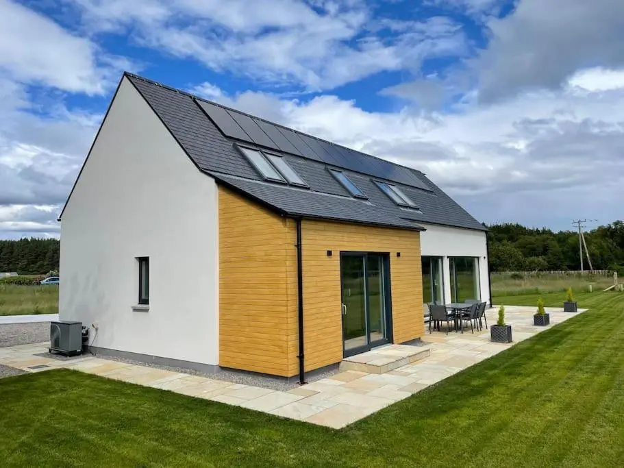 a house with a solar roof on a lawn at Ash Mill - Dornoch in Dornoch