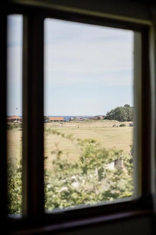 a view of a field from a window at Fairways - Seasgair Lodges in Nairn