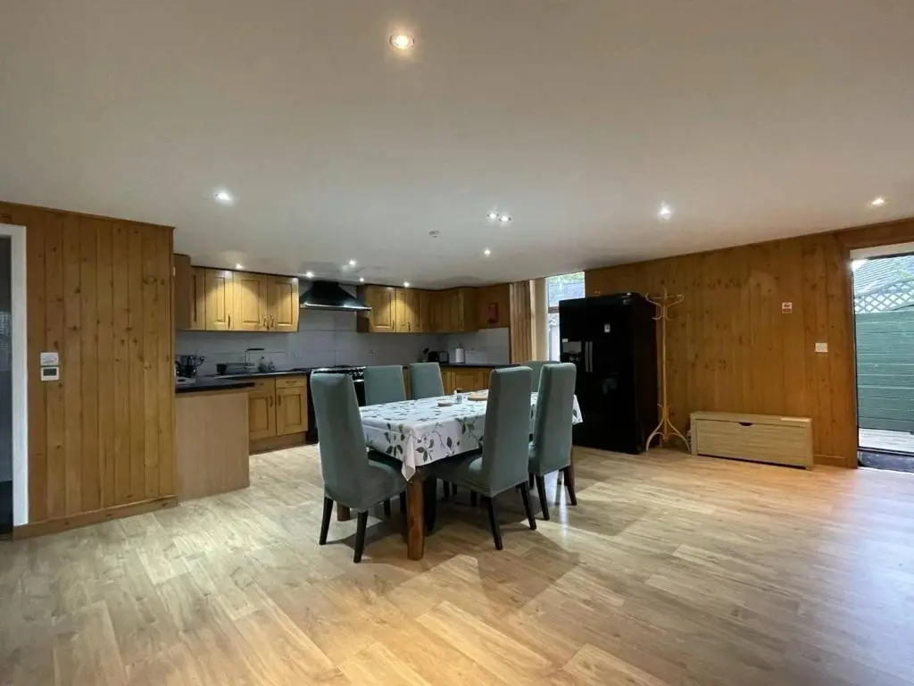a kitchen and dining room with a table and chairs at Sunshine three bedrooms Apartment in Insch