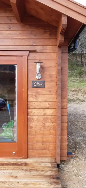 a wooden building with a sign on the side of it at Cobblehouse Country Cabins no TRADE WORKERS in Inverkeithny